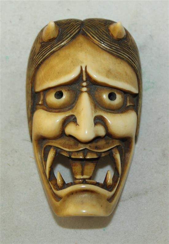 A Japanese Oni mask Manju netsuke, 19th century, 4.9cm